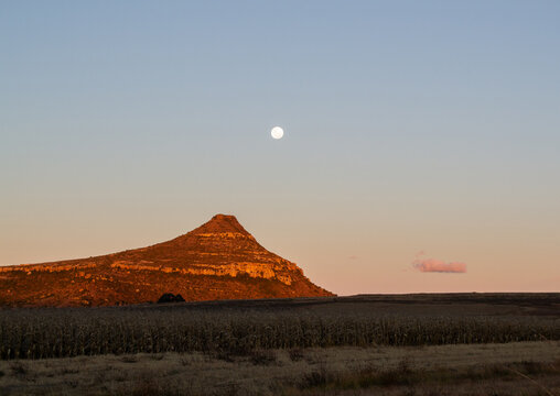 A hill in Clarens, South Africa, on a clear sunset evening, with the moon visible in the sky.