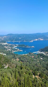 Aerial view of the famous bays of Angelokastro, northwest coast of Corfu. Paleokastritsa. Kerkyra island. Greece. Sunny summer landscape of green mountains and blue cloudy sky.