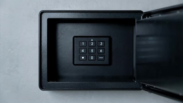 Focused medium shot of a digital lockbox door with a numeric keypad keys visible inside through a tinted window background blurred.