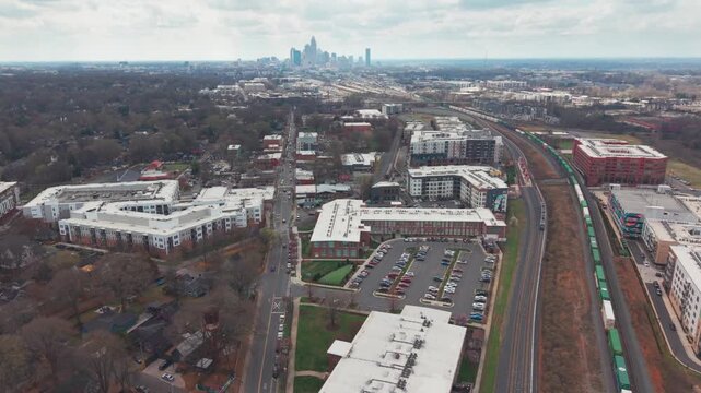 Light rail passes traditional freight train in NODA neighborhood of Charlotte, North Carolina, USA