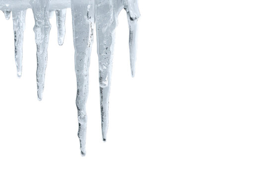 Icicles hanging, clear transparent frozen water objects in cold winter, falling ice drops, sharp frozen stalactites