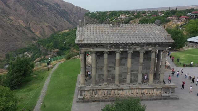 Drone footage reveals the majestic ancient temple of Garni, perched on the edge of a dramatic cliff overlooking a picturesque gorge, and teeming with tourists.