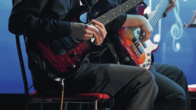Two musicians play electric and bass guitars on stage. Dynamic close-up on hands passion during a concert. Cool blue light and musical notes create an atmospheric background
