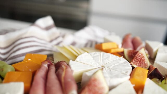 Cheese Board With Fruits And Ham On A Table As Charcuterie Board For Party