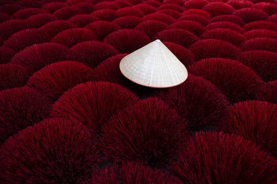 Traditional vietnamese hat non la on deep red dry incense sticks