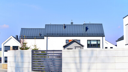 Fototapeta premium The real estate market in the suburbs. Terraced family homes in newly developed housing estate. New single family houses in a new development area. Residential homes with modern facade. 