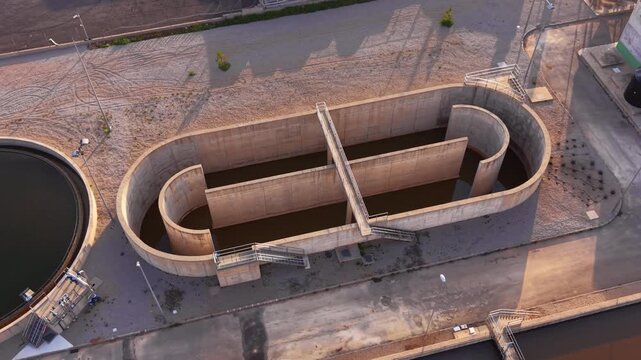 Drained serpentine contact basin with baffles and bridge, designed for plug-flow disinfection and controlled hydraulic retention time during maintenance.