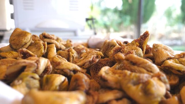 Detail view on pile of dried figs. Close up of falling sweet and tasty berries. Healthy food concept. Slow motion Side view