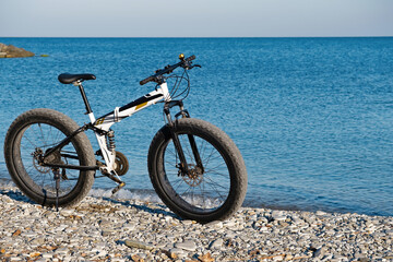 Fototapeta premium Parked on the beach bike waiting for the continuation