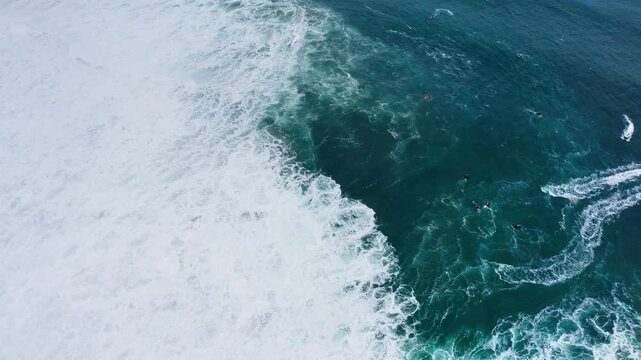 Majestic 4K personal watercraft PWC on incredible Atlantic Ocean waves during international surfers challenge in Nazare. Farol da Nazar&eacute;, Portugal where Guinness World Record highest surfing was set