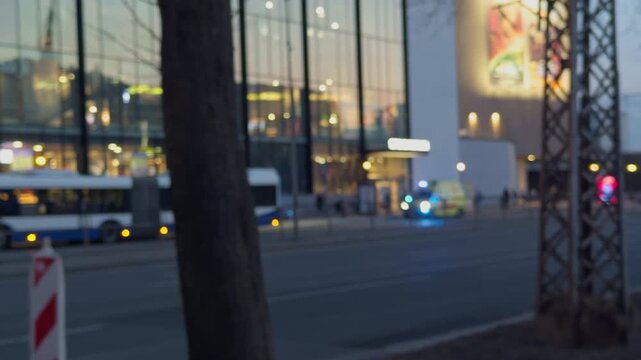 Nighttime street scene with reflections. Reflective glass and illuminated advertisements in city environment