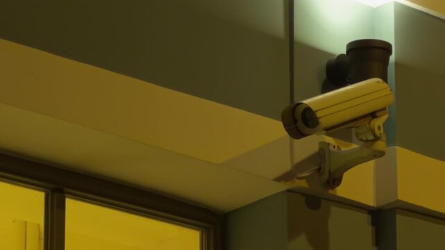 Industrial mounted surveillance device. Urban surveillance setup featuring shadow casting interior illumination and downward lens angle