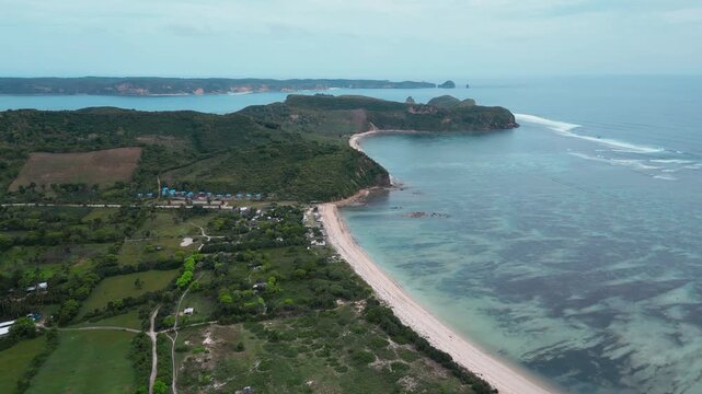 Aerial Reef Lagoon With Long Sheltered Bay, Clear Shallow Flats And Turquoise Channels, Gentle Breakers Along Outer Reef, Narrow Sandy Shoreline, Katil beach,Kuta,Lombok,Indonesia