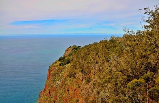 Panoramic view of the towering Cabo Girao cliffside in Madeira, featuring rugged textures and ocean serenity.