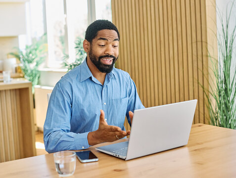 Portrait of a young blackman with laptop at home office
