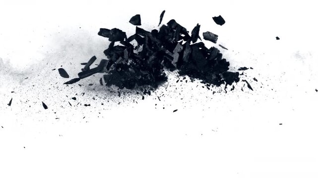 Super Slow Motion Flying and Colliding Charcoal Isolated On White Background at 1000 fps.