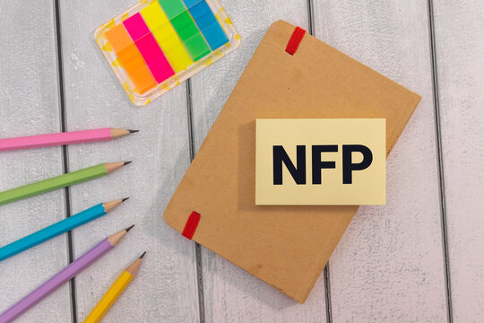 The word NFP is written in black marker on the yellow paper for notes.