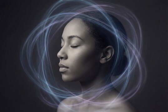 Contemplative female model surrounded by ethereal light trails symbolizing clarity and introspection in a minimalist monochromatic composition exuding inner peace and elegance