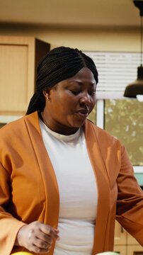 African american woman, answering questions, comment section, influencer engaging with audience after filming video. Content creator recording homemade food vlog, making a recipe.