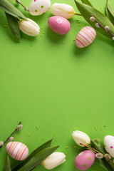 Fototapeta na wymiar Easter celebration with decorated eggs and tulips on a bright green background