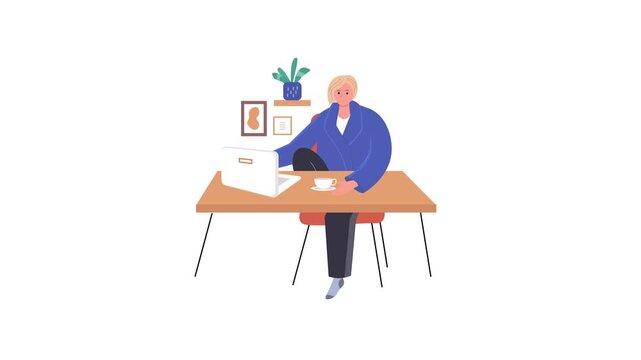 Friendly senior woman working on laptop at home office table with tea cup and decor