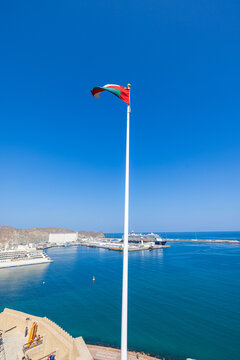 Muscat, Oman &ndash; December 28, 2025: View from Mutrah Fort overlooking Muscat harbor with a large cruise ship anchored in the turquoise waters of the Gulf of Oman. The scene captures historic defensive w
