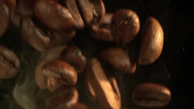 Super Slow Motion Macro of Coffee Beans Falling on Black Background at 1000fps.