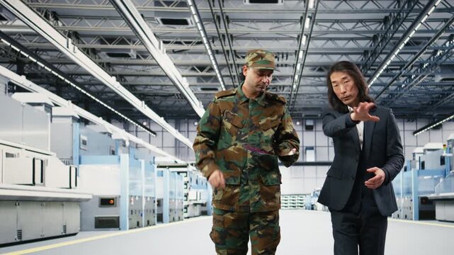Soldier and engineer in microchip factory enforcing measures to increase semiconductor production. Army officer collaborates with technician to minimize reliance on foreign supply chains, camera A