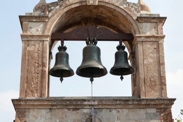 Obraz premium Historic Bell Tower – Three Bells in Arched Structure