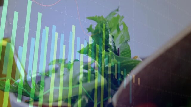 Vertical video: Right hand entering frame picking salad leaves on table chart measuring food data