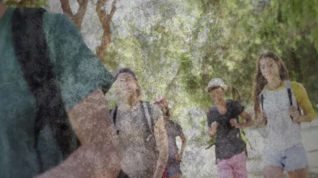 Vertical video: Fedora man waving 4 campus students coming greeting camera paint overlay over packs