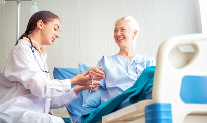 Professional Medical Doctor diagnosing and giving advice to the elderly patient at hospital. Healthcare homecare concept