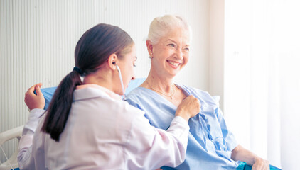 Professional Medical Doctor diagnosing and giving advice to the elderly patient at hospital. Healthcare homecare concept