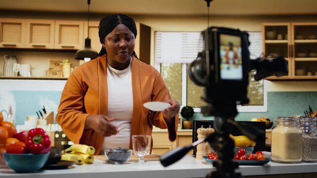 Woman influencer, chia seeds bowl, meal prep step by step, kitchen tutorial, black food blogger showcasing healthy breakfast meal recipe and filming culinary vlog. Lifestyle video online.