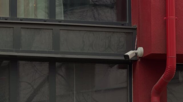 Live camera footage. City scene captured in real time. Surveillance camera films city view during day