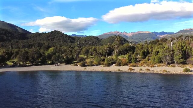 Aerial shot of the Lago Futalaufquen beach in Argentine Patagonia near the city of Esquel Chubut. The camping sector and larch forest are visible on a sunny 