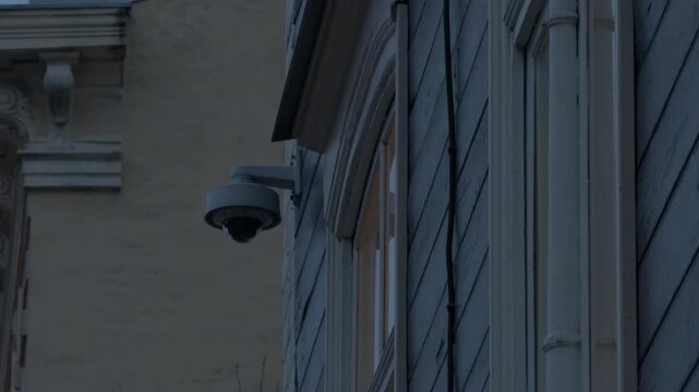 Reflective dome mounted over intricate architectural feature monitors street environment and heritage preservation