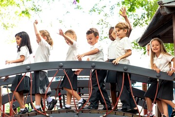 Children joyfully crossing bridge photo