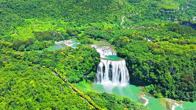 Aerial view of Huangguoshu Waterfall, one of the largest waterfalls in China, surrounded by lush green mountains in Anshun, Guizhou.