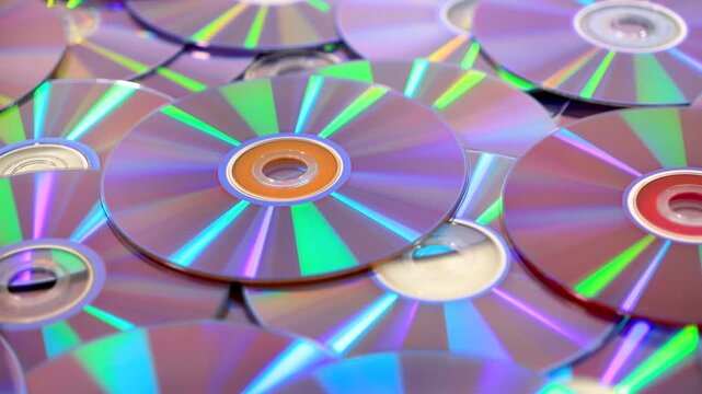 Holographic light reflecting on a pile of compact discs