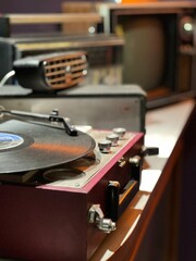 An old vinyl record player against the background of other old equipment © Constantine Rafikov