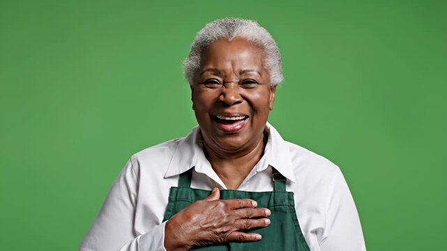 Joyful Senior Woman Laughing with Green Background