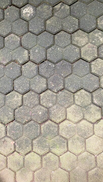 Top view of grey trihex paving blocks in a classic herringbone pattern
