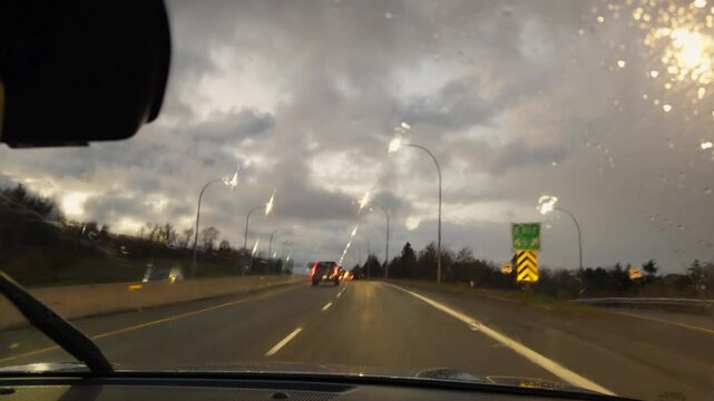 Real-time windshield POV: night drive in pouring rain across Halifax bridges and city streets. Raindrops create dynamic patterns, colorful light reflections, moody Nova Scotia urban night 4K.