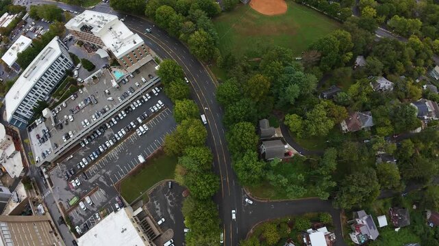 Aerial Asheville Winding Road Connecting Parking Area And Greenbelt, Curving Through Mature Tree Canopy, Scattered Homes Along Route, Light Commuter Flow, Study Of Transit Corridor