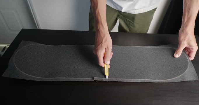 Cut Grip tape sandpaper for a Skateboard Deck.  