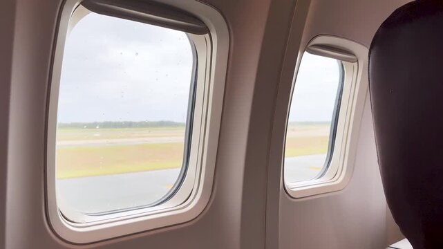 View from Airplane Window of Rainy Airport Runway in Palau
