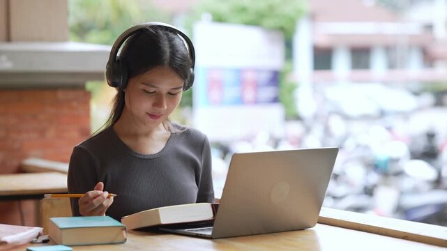 Young Asian Woman University Student Using Laptop for Learning