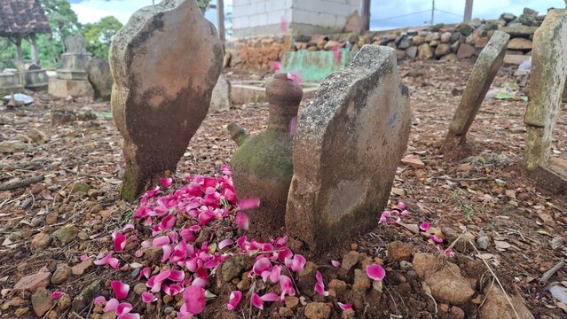 Grave with Tombstone Covered in Rose Petals as Indonesian Mourning Tradition