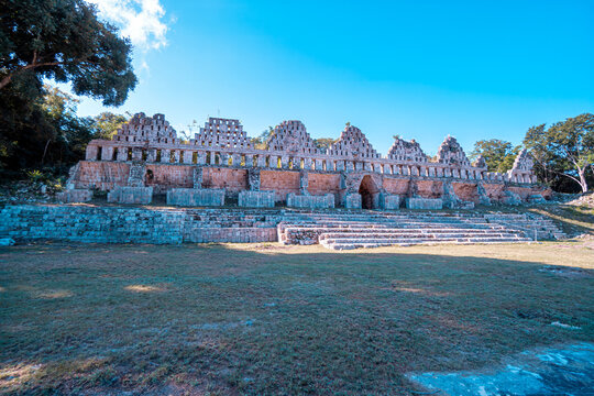 Ancient stone structures rise under clear blue skies